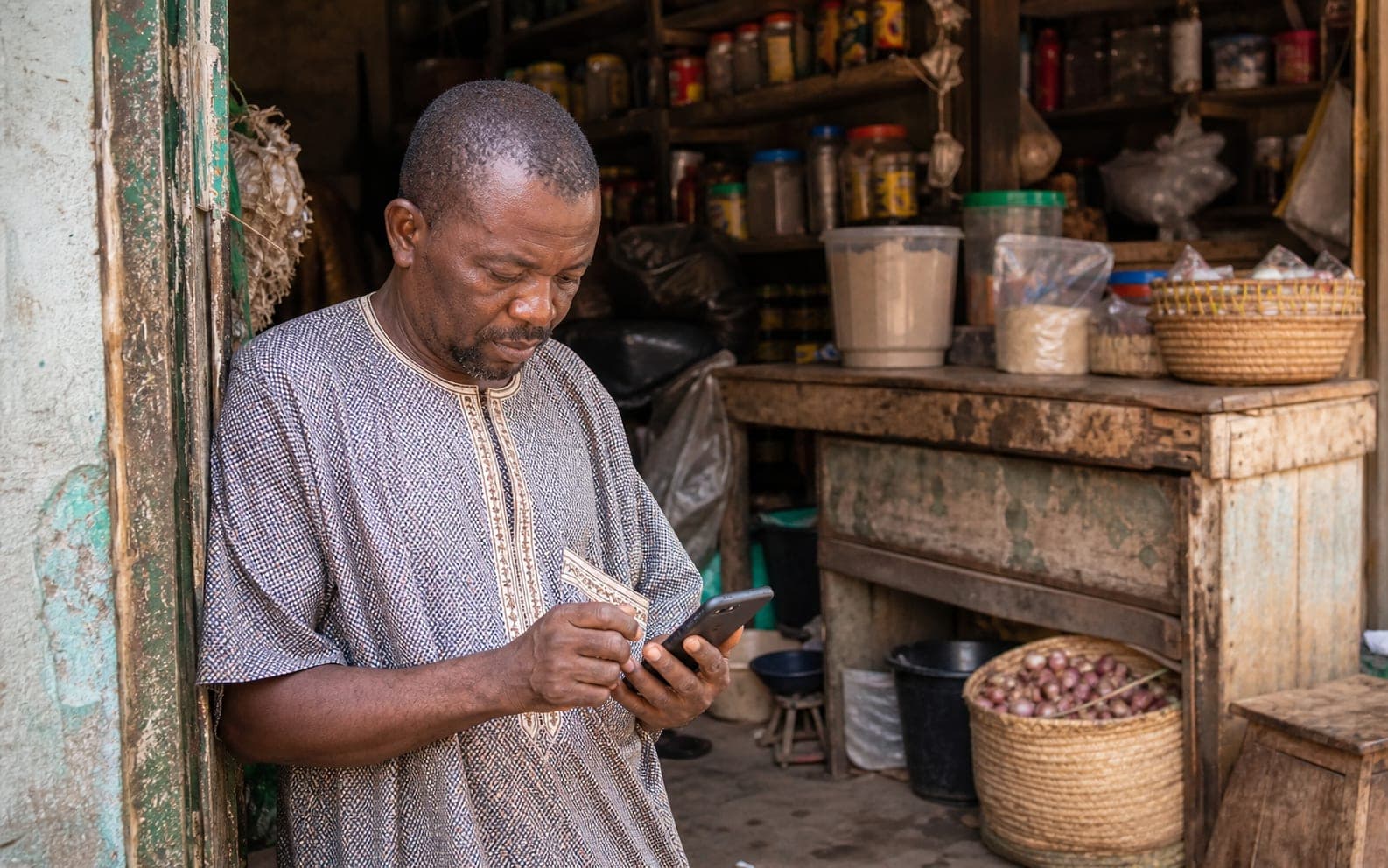 An agent completing the Lukeport application on a phone behind the counter